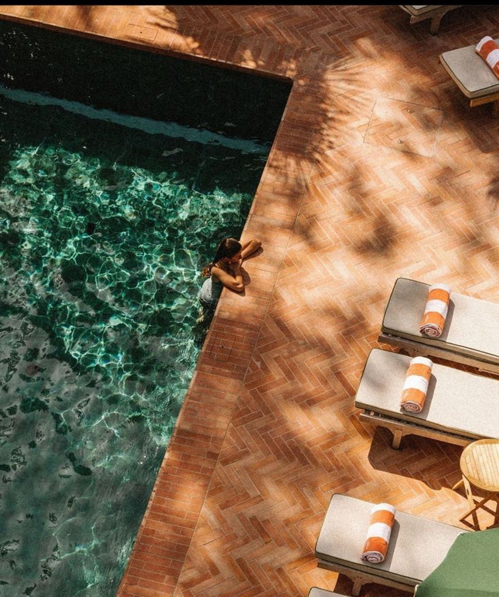 The pool in terracotta light at the end of the day
